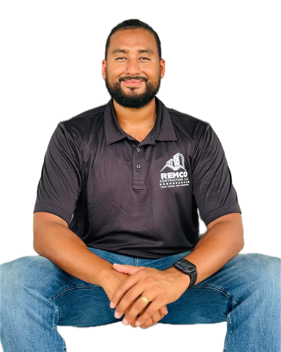 Devon Garcia, owner of Remco Roofing, smiling in a black Remco Contracting polo